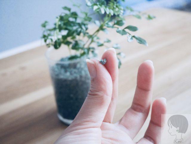 ダイソーで購入したゼオライトの粒を指でつまむ